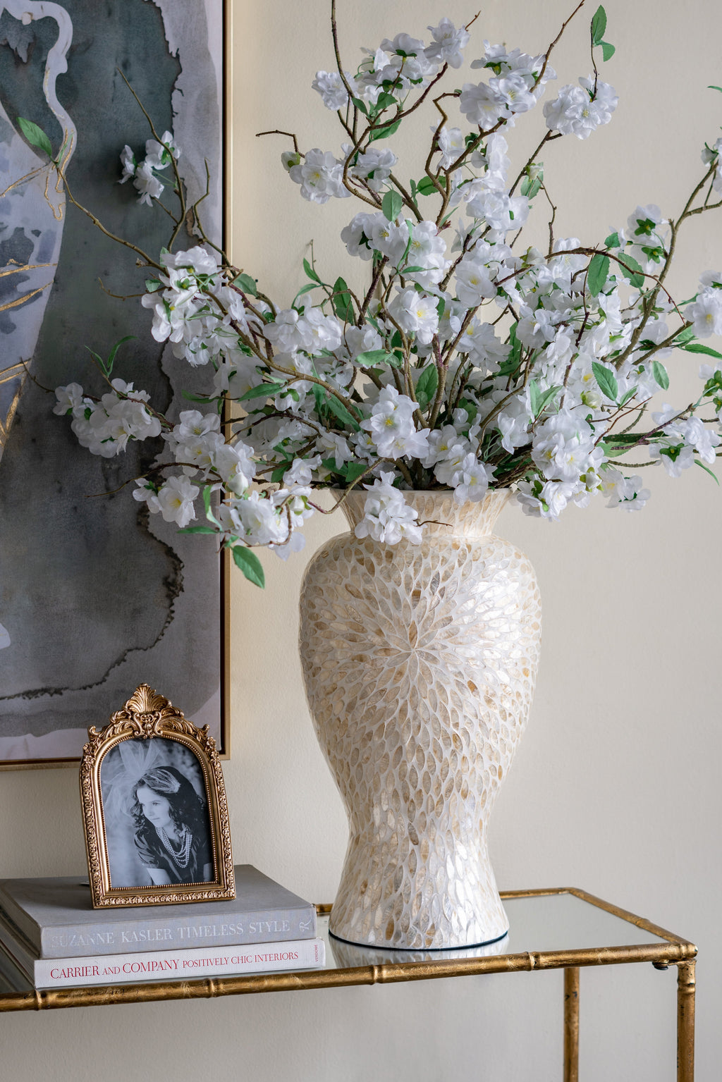 Gold and white Capiz shell motif vase styled with white blossoms