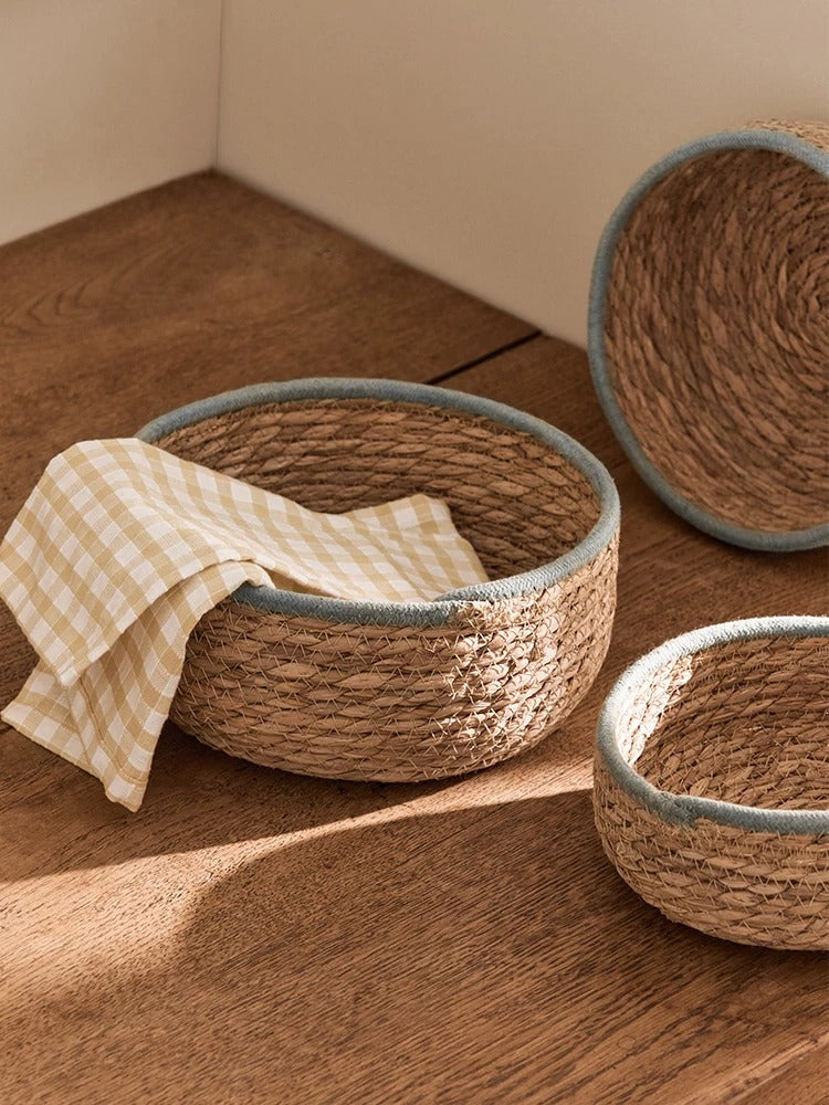 Natural woven seagrass storage baskets with blue-gray rims — view 5