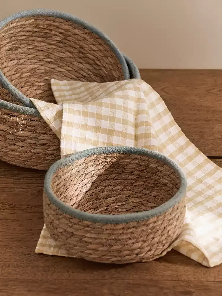 Natural woven seagrass storage baskets with blue-gray rims — view 4