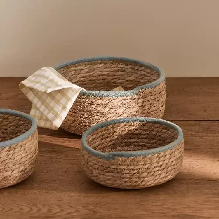 Natural woven seagrass storage baskets with blue-gray rims — view 3